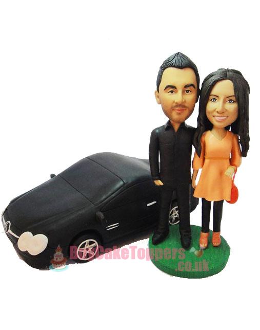 couple with car wedding cake topper